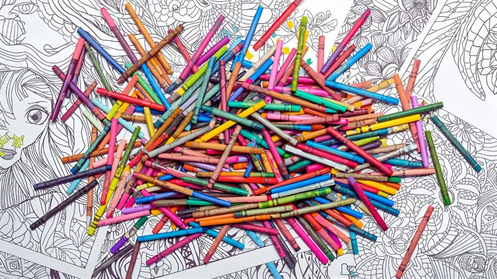 Professional arrangement of various coloring tools including colored pencils, markers, gel pens, and crayons alongside sample coloring pages showing different techniques Crayons, pastels, and chalk markers for creative coloring