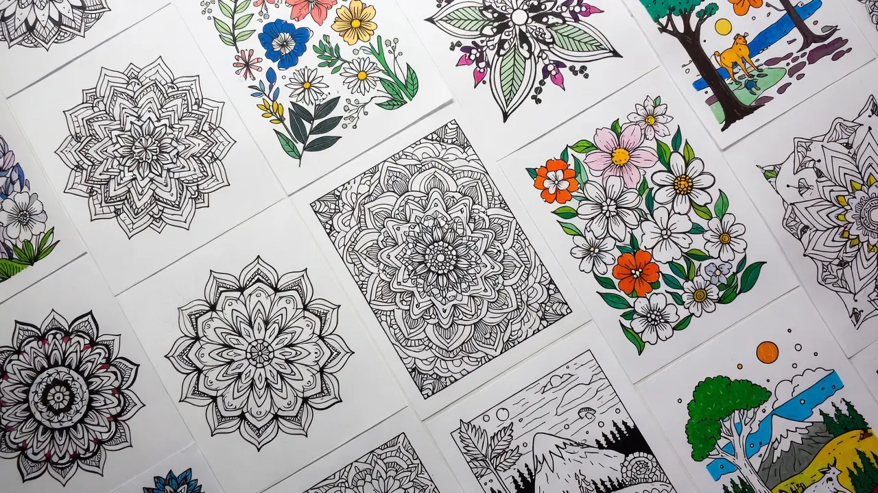 Variety of different coloring page styles spread out - mandalas, florals, geometric patterns, nature scenes. Coloring for anxiety